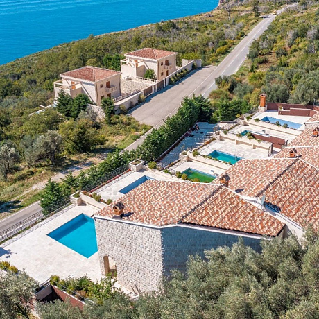 A complex of 6 villas with a swimming pool with an open sea view
